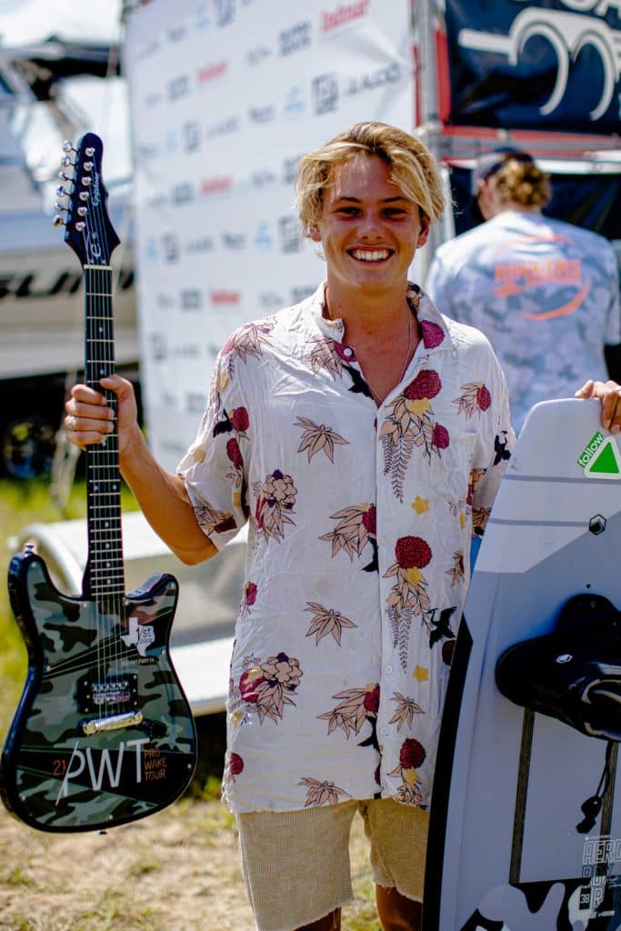 Sam Brown holding guitar after winning PWT Stop #1