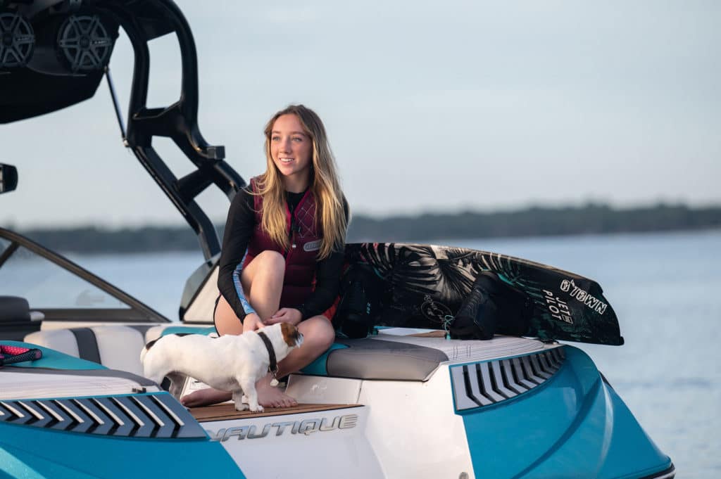 Kira Lewis on the boat with a dog