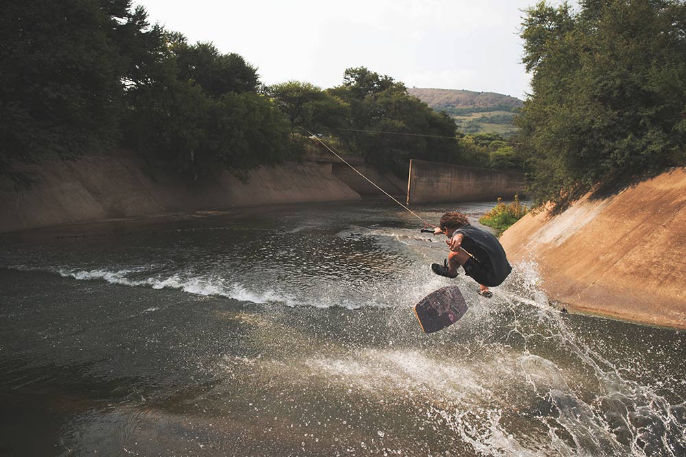 cole kriss wakeskating kickflip into bank