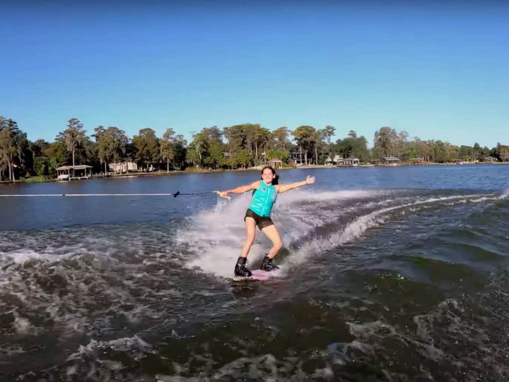 Hollie Waldrop carving behind the boat