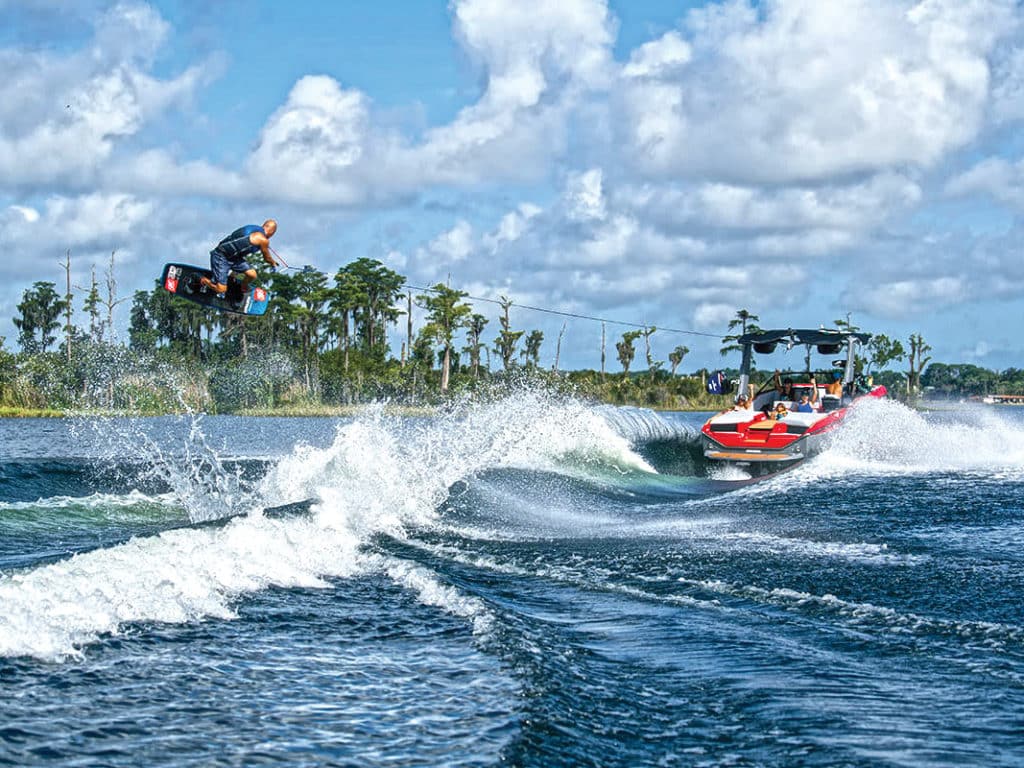 Wakeboarder launching over wake