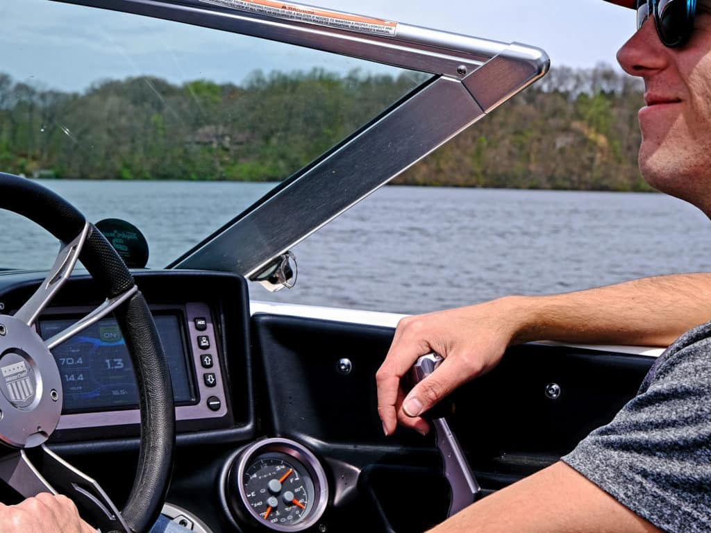 Driver at helm of watersports boat