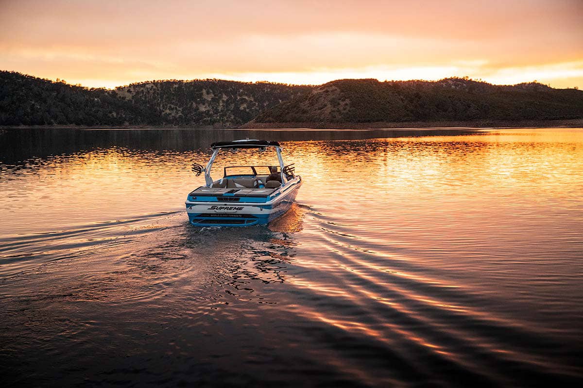 Supreme boat on the water at sunset