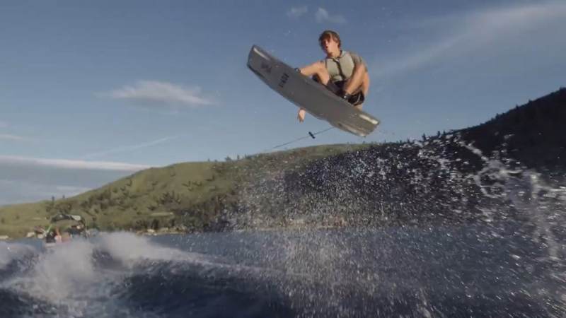 Wakeboarder catching air on the water