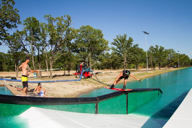 Wake Brothers Bob Soven back lipping the downrail at BSR Wake Park in Waco Texas during the Liquid Force Wakeboards Free for All