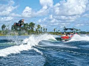 BTG0522-QST-Learn-Wakeboard Wakeboarder launching over wake