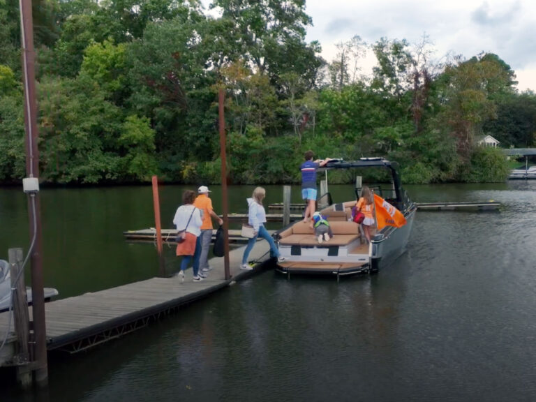 Family boarding a wakeboard boat