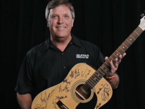 Rick Tinker with signed guitar
